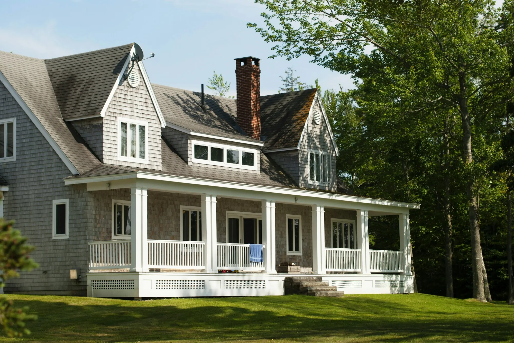 Gray shingled house with a white porch